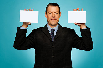 Image showing Businessman showing two blank white placards