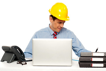 Image showing Young architect actively working at his desk