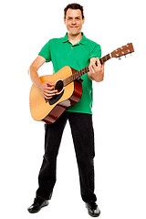 Image showing Young caucasian guitarist playing tracks