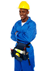 Image showing Smiling african worker posing with arms crossed