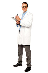 Image showing Young physician writing medical report