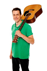 Image showing Handsome casual man with guitar on shoulders