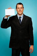 Image showing Isolated corporate man holding blank placard