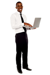 Image showing Full length portrait of businessperson holding laptop