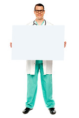 Image showing Male doctor displaying white advertising board