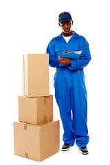 Image showing Delivery boy at work. Kindly accept your goods