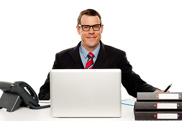 Image showing Confident smiling male executive wearing glasses