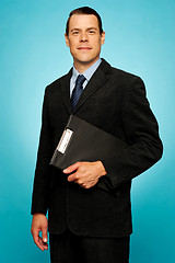 Image showing Corporate man holding clipboard and posing