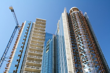 Image showing Modern high-rise building under construction and a crane.  