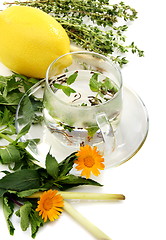 Image showing Teacup, herbs and lemon.