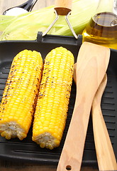 Image showing Corn on the grill pan and wooden spoon.