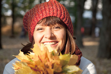 Image showing woman with autumn orange leaves