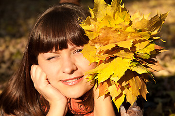 Image showing woman with autumn leaves