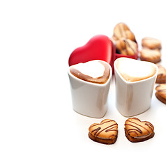 Image showing heart shaped cream cookies on red heart metal box and coffee