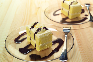 Image showing fresh cream cake closeup with chocolate sauce