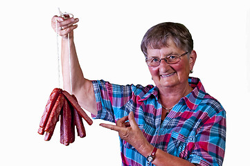Image showing female butcher with smoked sausage