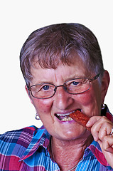 Image showing Grandma enjoys smoked sausage
