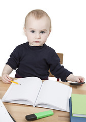 Image showing young child at writing desk