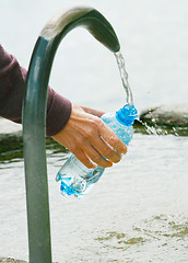 Image showing fountain of spring water bottle filling holding hand in Lugano, 