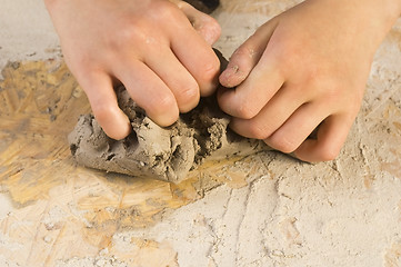 Image showing Child hands of a potter