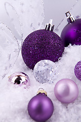 Image showing beautiful christmas decoration in purple and silver on white snow