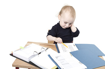 Image showing young child at writing desk