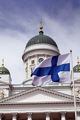 Image showing fluttering national flag of Finland against Helsinki Cathedral