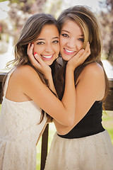 Image showing Attractive Mixed Race Girlfriends Smile Outdoors
