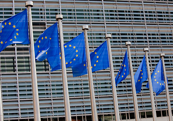 Image showing European flags in front of the Berlaymont building, headquarters of the European commission in Brussels.