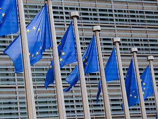 Image showing European flags in front of the Berlaymont building, headquarters of the European commission in Brussels.