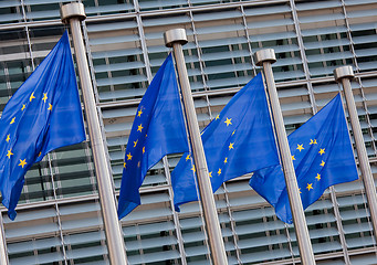 Image showing European flags in front of the Berlaymont building, headquarters of the European commission in Brussels.