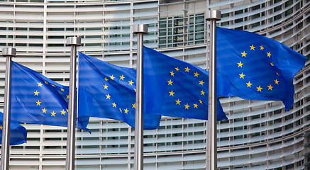 Image showing European flags in front of the Berlaymont building, headquarters of the European commission in Brussels.