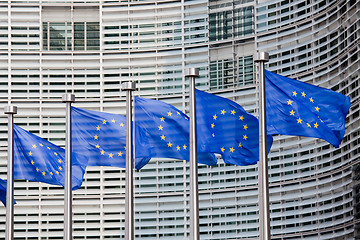 Image showing European flags in front of the Berlaymont building, headquarters of the European commission in Brussels.