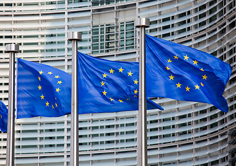 Image showing European flags in front of the Berlaymont building, headquarters of the European commission in Brussels.