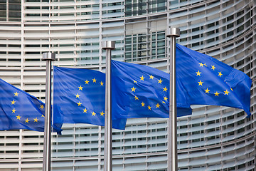 Image showing European flags in front of the Berlaymont building, headquarters of the European commission in Brussels.