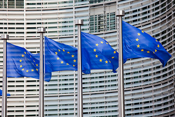 Image showing European flags in front of the Berlaymont building, headquarters of the European commission in Brussels.