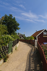 Image showing Narrow street and red cottages in Sweden