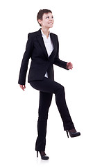 Image showing woman stepping on imaginary step