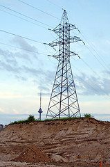 Image showing High-voltage power poles wires television tower 