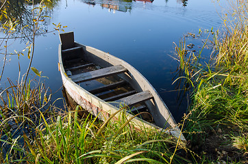 Image showing Retro wooden boat on lake shore. water transport 