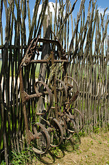 Image showing Old corroded field harrow tool stand wooden fence 