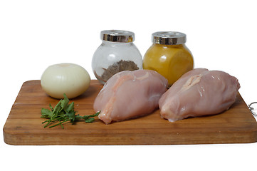 Image showing  A pair of skinless chicken breasts on a cutting board