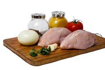 Image showing  A pair of skinless chicken breasts on a cutting board