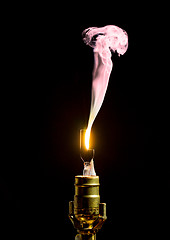 Image showing Broken lightbulb flares up in smoke