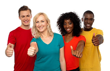 Image showing Smiling team of young people showing thumbs up