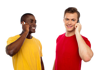 Image showing Two handsome men communicating on cellphone