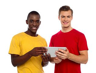 Image showing Technology savvy friends using tablet pc