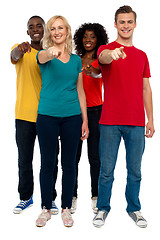 Image showing Cheerful group of teenagers pointing at you