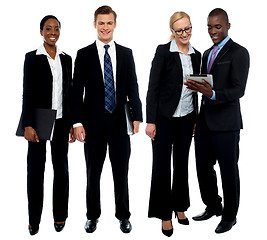 Image showing Corporate team of four posing with tablet pc