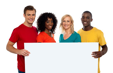 Image showing Group of youth displaying blank advertise board
